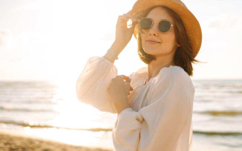Happy, glowing woman on a beach. Farmhouse Fresh Limited-time Seasonal Summer Spa Treatments