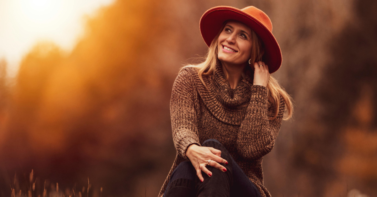 Woman outside smiling in a fall sunset - Fall Refresh Facials